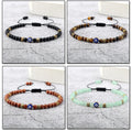 Four evil eye bracelets with matte black, banded brown, flecked reddish brown and pale green beads