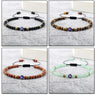 Four evil eye bracelets with matte black, banded brown, flecked reddish brown and pale green beads