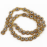 Transparent amber-brown flat round beads with white eye rings and black centers