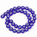 Dark blue flat round beads with pale blue and white eye rings surrounding black centers