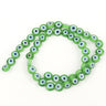 Green flat round beads with white and pale blue eye rings surrounding black centers