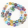 Multicolored flat round evil eye beads with rainbow reflections, arranged in a loop