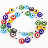 A looped strand of multicolored flat round beads with white eye rings and dark centers