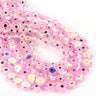 Overlapping strands of pink flat round evil eye beads with rainbow reflections