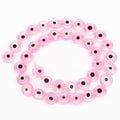 Transparent pink flat round beads with dark eye centers, arranged in a loop