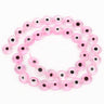 Transparent pink flat round beads with dark eye centers, arranged in a loop