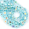 Overlapping strands of pale turquoise flat round evil eye beads with rainbow reflections
