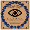 Glossy blue banded bead bracelet with a blue eye bead and silver tone spacers on a printed card