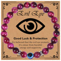 Glossy purple banded bead bracelet with a blue eye bead and silver tone spacers on a printed card