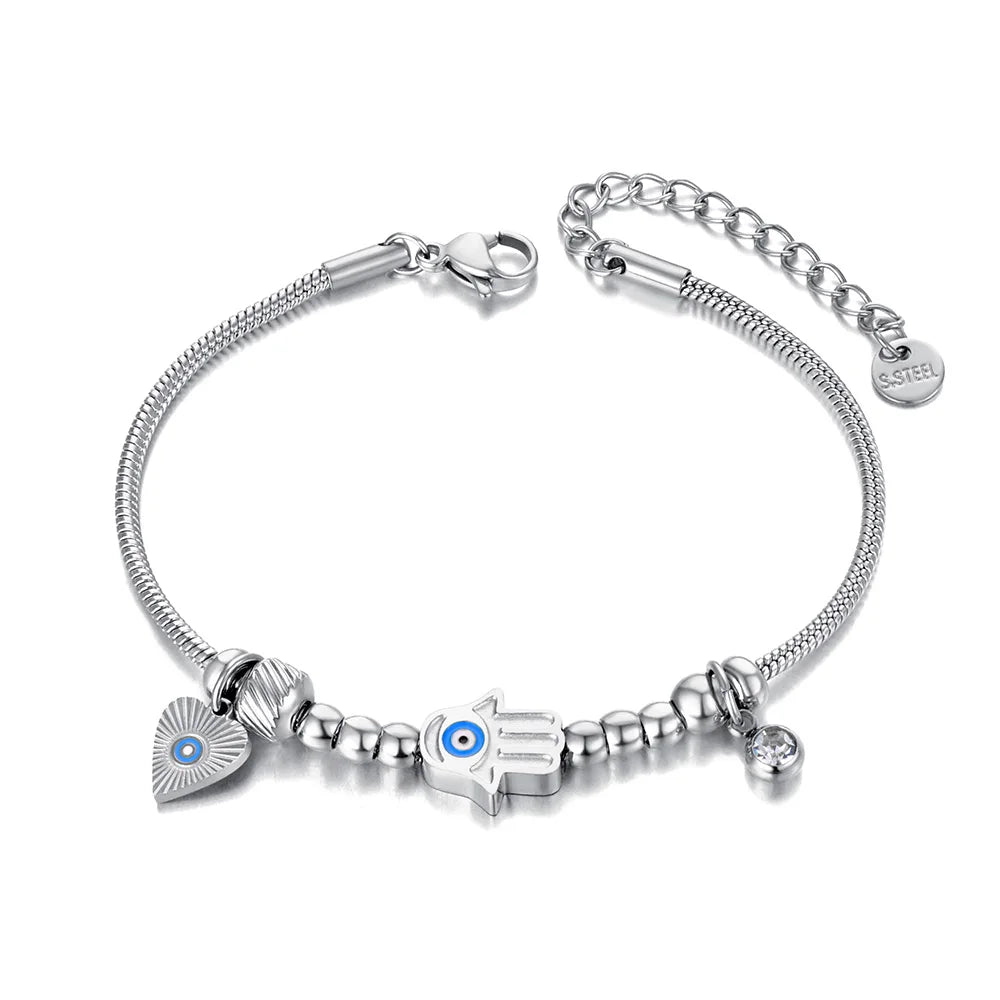 Silver tone snake chain bracelet with a blue-eyed Hamsa hand, heart charm and clear round drop