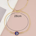 Blue evil eye cord bracelet with a circular measurement guide labeled 28 cm