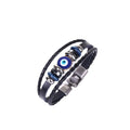 Black bracelet with twin braided strands, a round blue evil eye centerpiece and a hook-and-slot clasp on a white background.