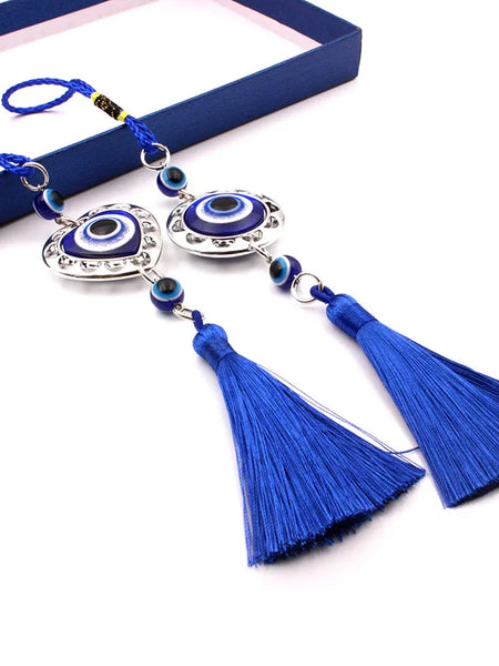 Round and heart-shaped blue evil eye ornaments with blue cord loops and tassels