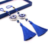 Round and heart-shaped blue evil eye ornaments with blue cord loops and tassels