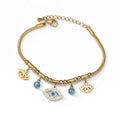 Gold tone chain bracelet with a central open eye charm, smaller eyelash charms, blue round accents and a clasp on a white background.