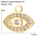 Gold tone open eye charm with clear accents around the border, a clear center and a single top loop, shown with annotations