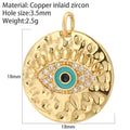 Textured gold tone disc charm with a turquoise and black eye, clear accents and measurement annotations
