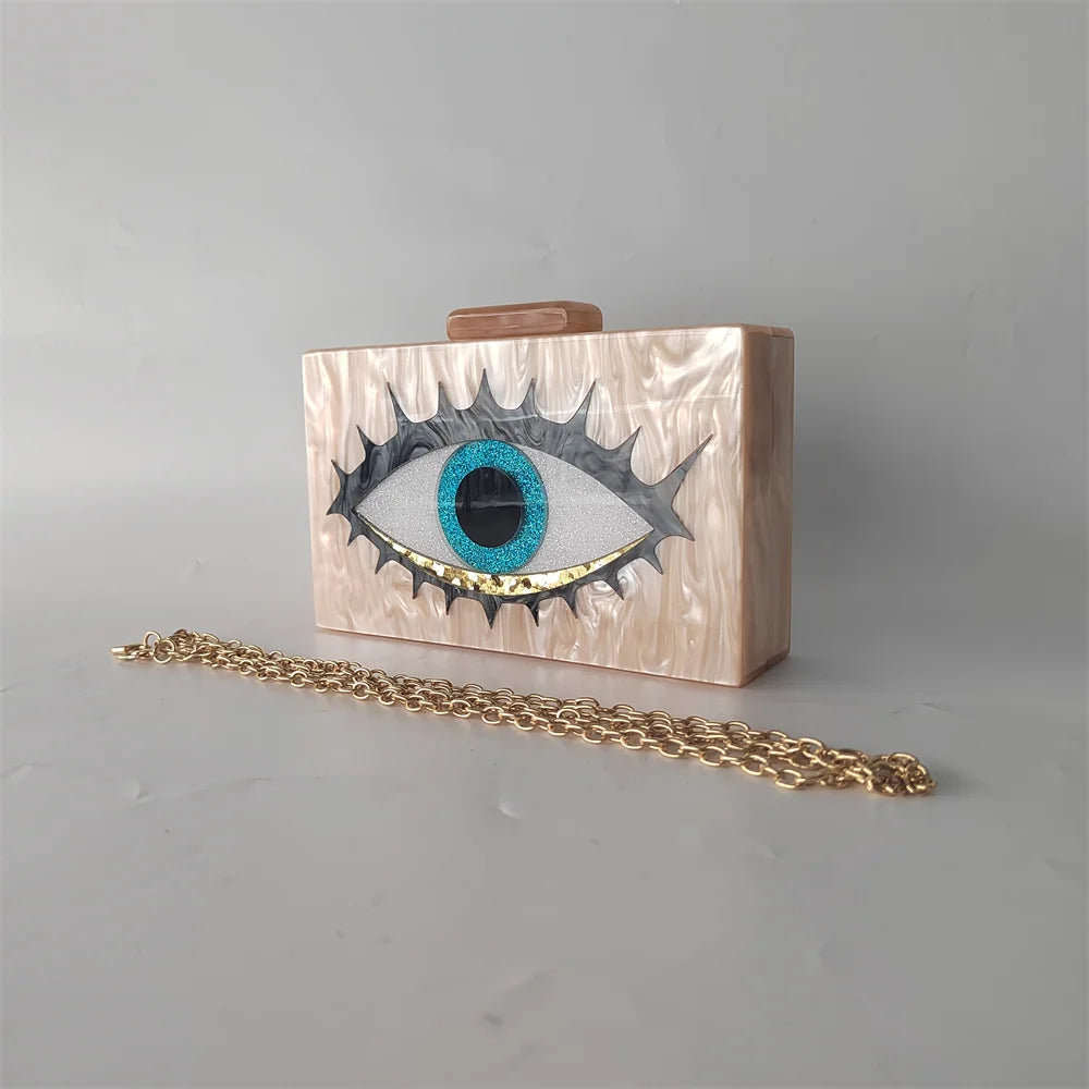 Cream marbled-effect Evil Eye clutch with a gold-tone oval-link chain in front