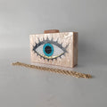 Cream marbled-effect Evil Eye clutch with a gold-tone oval-link chain in front