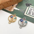 Gold tone and silver tone floral circle connectors with colorful eye motifs and loops at opposite ends.