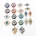 Oval eye, almond eye, Hamsa and floral circle connector charms arranged on a white background.