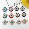 Oval Evil Eye connectors arranged in three rows, showing six border colors with gold tone and silver tone frames.