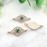 Gold tone almond eye connectors with turquoise centers and clear accents, showing fronts and a grooved back.