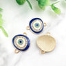Blue oval Evil Eye connectors with gold tone frames, showing decorated fronts and a grooved back.