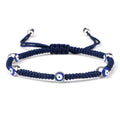 Blue knotted cord bracelet with five spaced blue eyes in silver tone borders