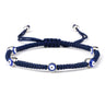 Blue knotted cord bracelet with five spaced blue eyes in silver tone borders
