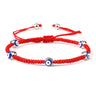 Red knotted cord bracelet with five spaced blue eyes in silver tone borders