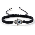 Black knotted cord bracelet with a single dotted silver tone Hamsa and blue eye