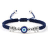 Blue cord bracelet with two patterned silver tone elephants around a central blue eye