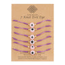 Six pink eye bracelets with purple knotted cords and gold tone spacers