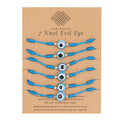 Six turquoise eye bracelets with blue knotted cords and gold tone spacers