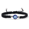 Black knotted cord bracelet with one round blue eye and silver tone beads