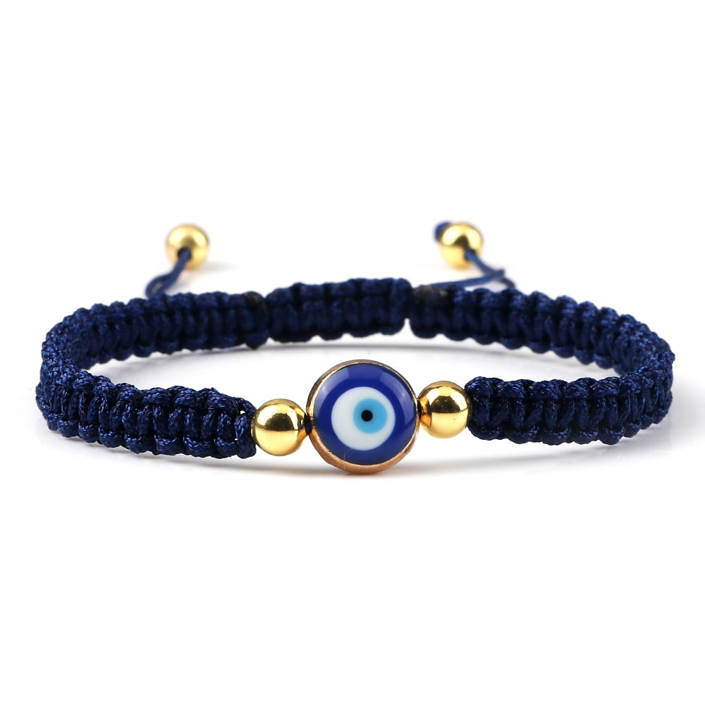 Blue knotted cord bracelet with a round blue eye and gold tone beads