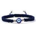 Blue knotted cord bracelet with one round blue eye and silver tone side beads