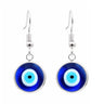 Front view of round blue evil eye drop earrings with silver tone frames and hook ear wires