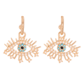 Gold tone eye drop earrings with turquoise-colored centers, rounded white border accents, radiating lashes and star tips.