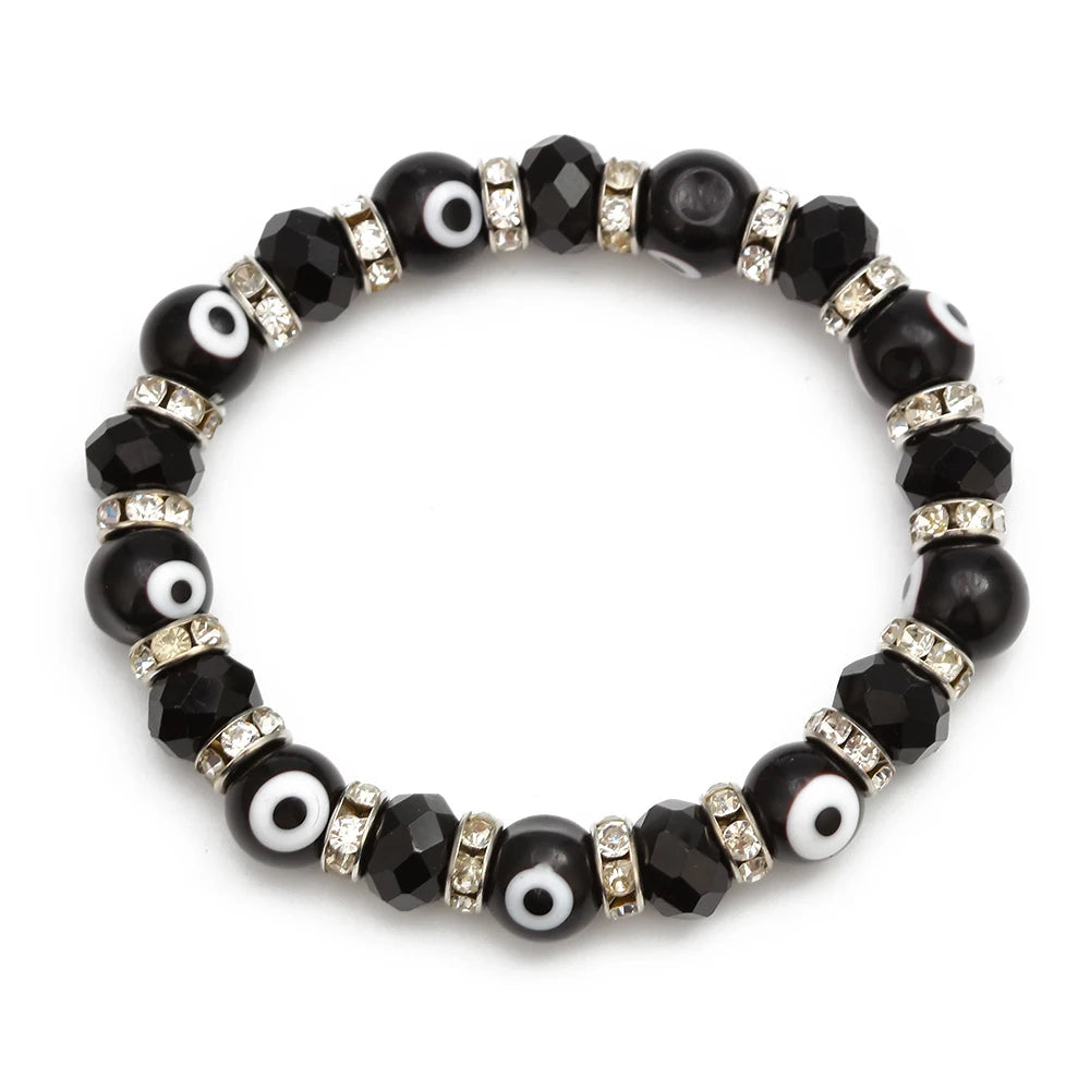 Black evil eye bracelet with rounded eye beads, faceted beads and silver tone spacer rings