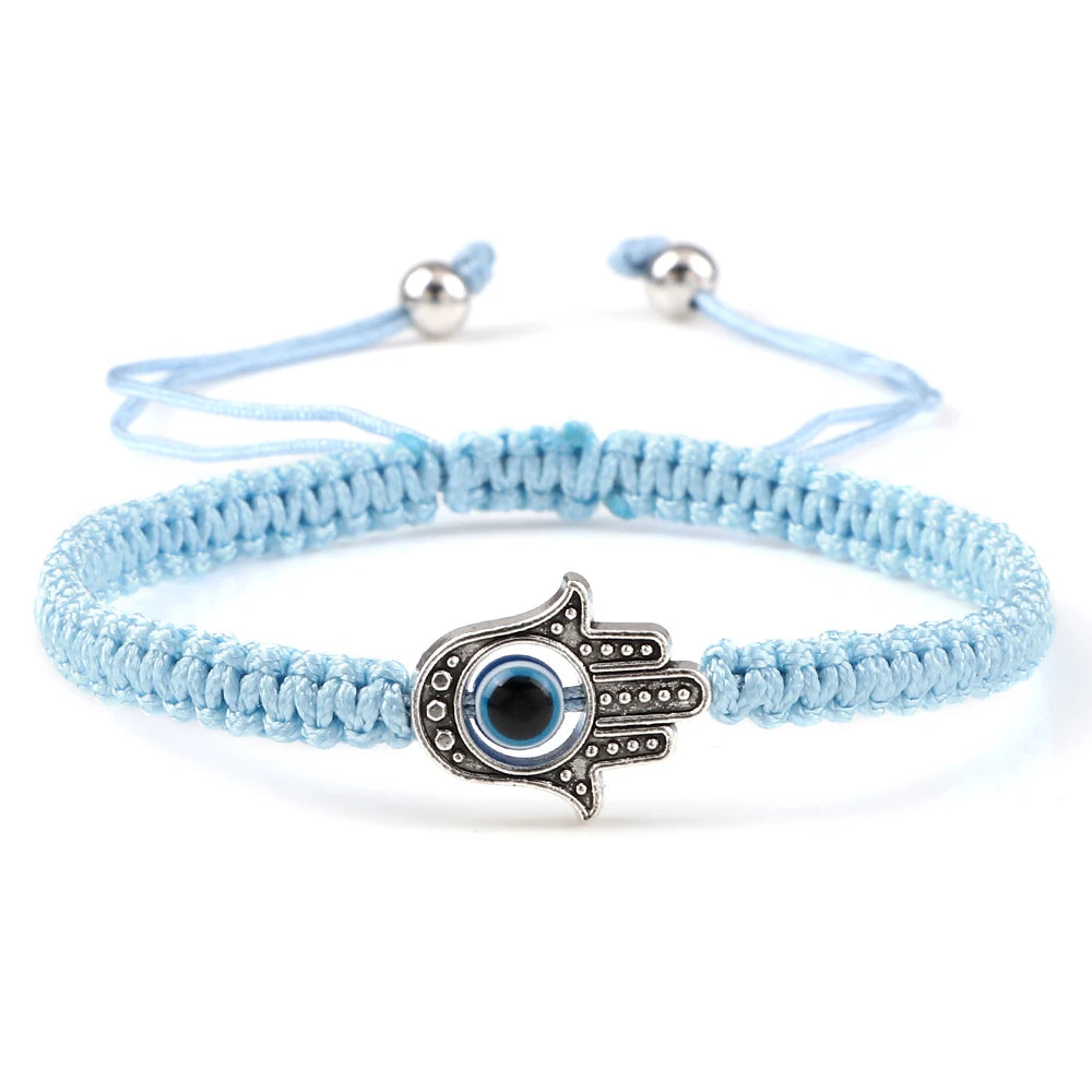 Light blue braided bracelet with a dotted silver tone Hamsa hand and blue eye