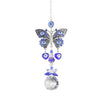 Silver tone butterfly with blue eye motifs, two blue heart drops and a clear faceted ball below