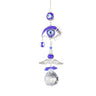 Open silver tone eye with curved lashes, blue beads, wing-shaped detail and a clear faceted ball
