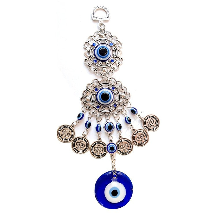 Two silver tone scrollwork eye medallions with blue beads, coin charms and a round blue eye pendant