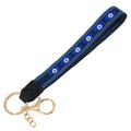 Navy loop keychain with six almond-shaped blue eyes, blue borders, a black tab and gold tone attachments.