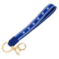 Royal blue loop keychain with six almond-shaped eye motifs, white borders and gold tone attachments.
