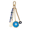 Keychain with a large blue eye medallion on a link chain, blue and white bead strands and a cream tassel