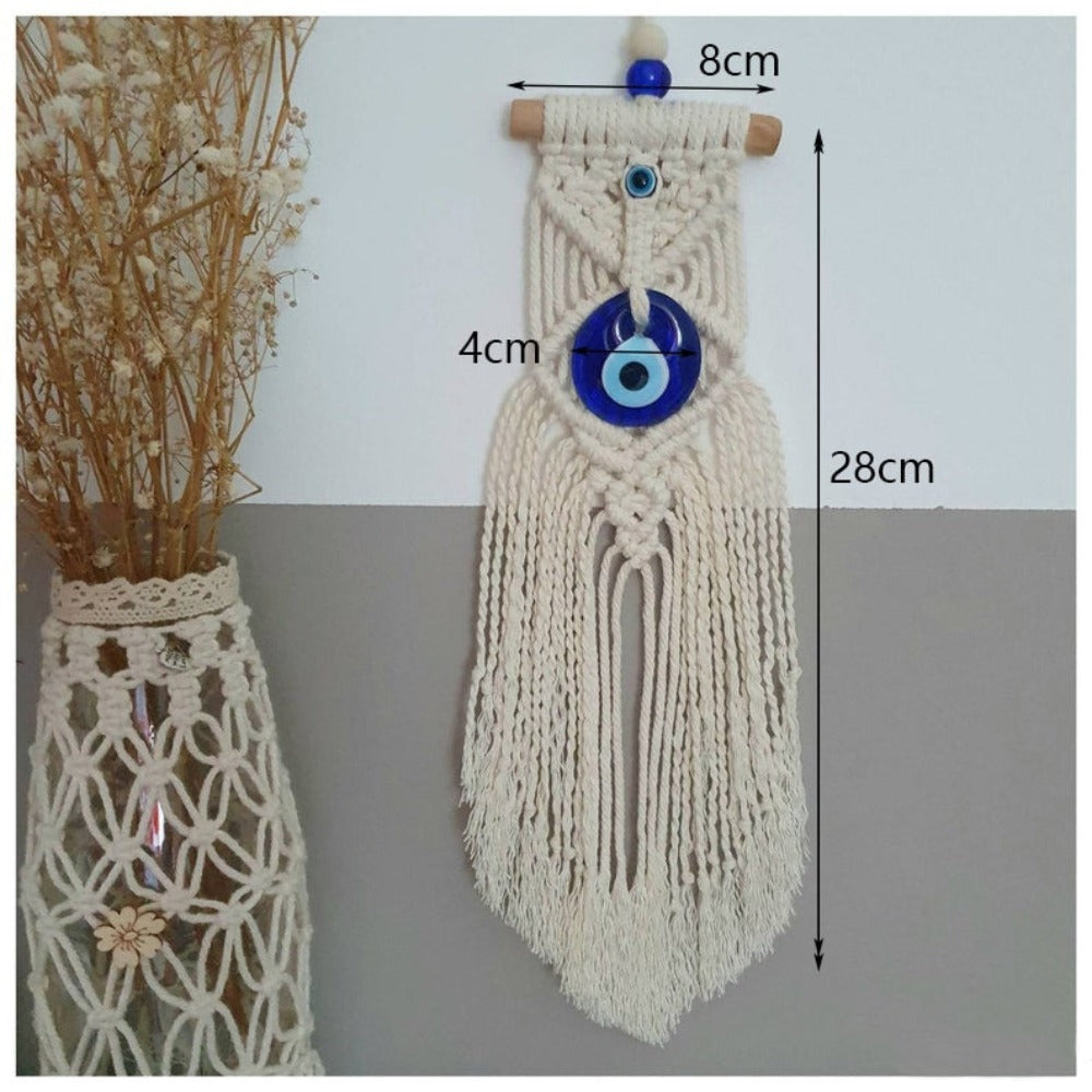 Long-fringe evil eye wall hanging with image annotations reading 8 cm across the top bar, 4 cm across the pendant and 28 cm vertically.
