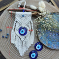 Side-tassel evil eye wall hanging with image annotations reading 12 cm across the top, 4 cm across the pendant and 30 cm vertically.
